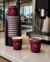 Cador 4 oz single wall cups beside coffee machine - lifestyle image